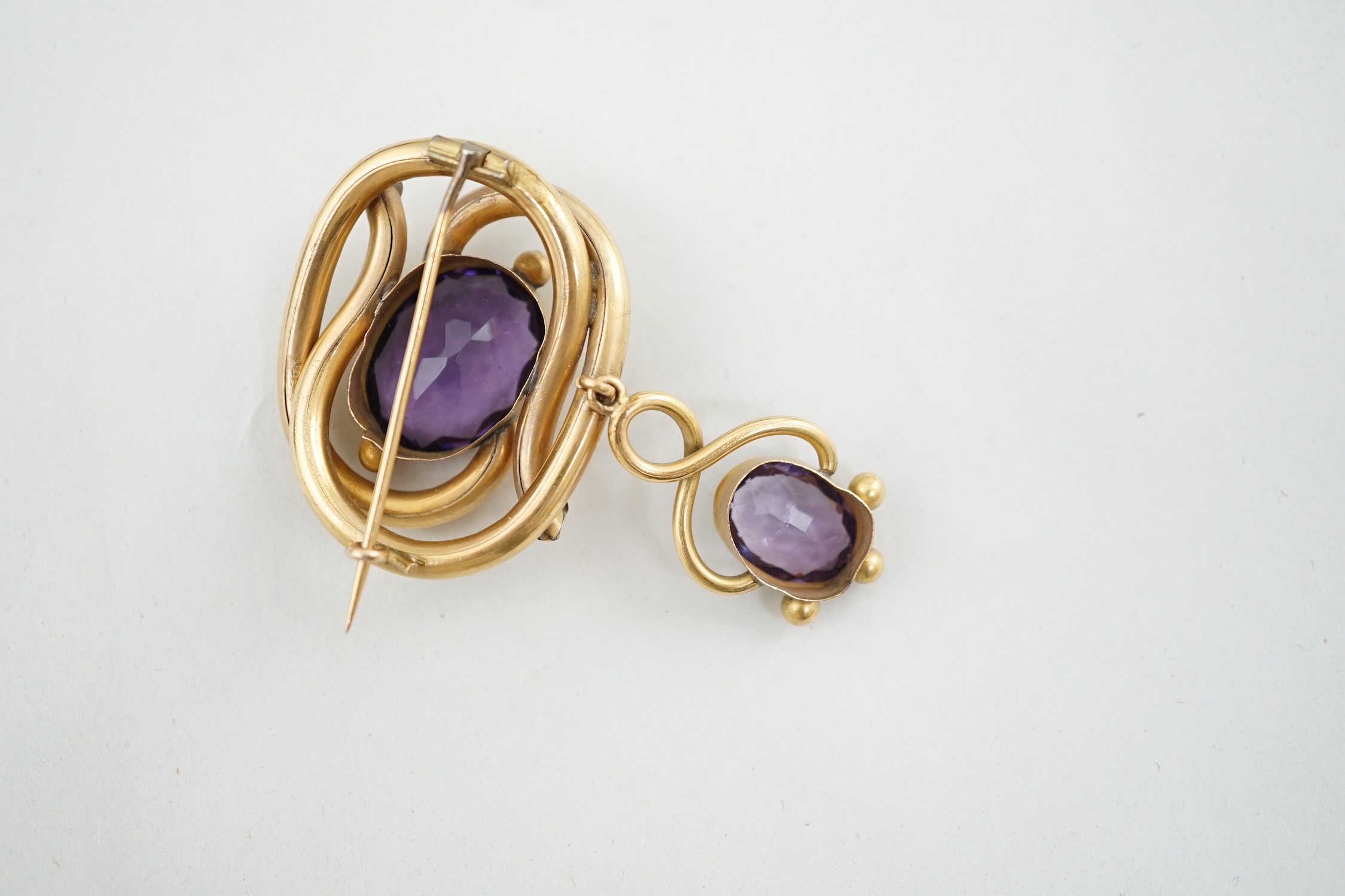 A Victorian gilt metal and two stone amethyst set drop brooch